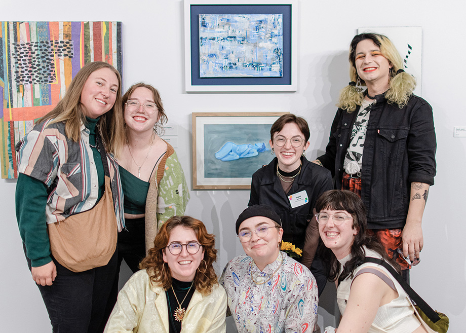 Artist Ingrid Hellevik and friends pose by Hellevik’s piece Fatigue in Blue, which was on display in the 2022 Members’ Exhibition.