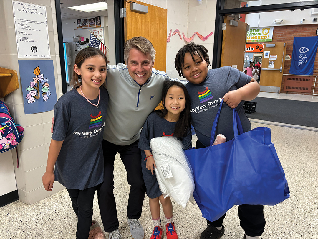 Marty Rathmanner, a donor and coach, with students at Willow Lane Elementary.