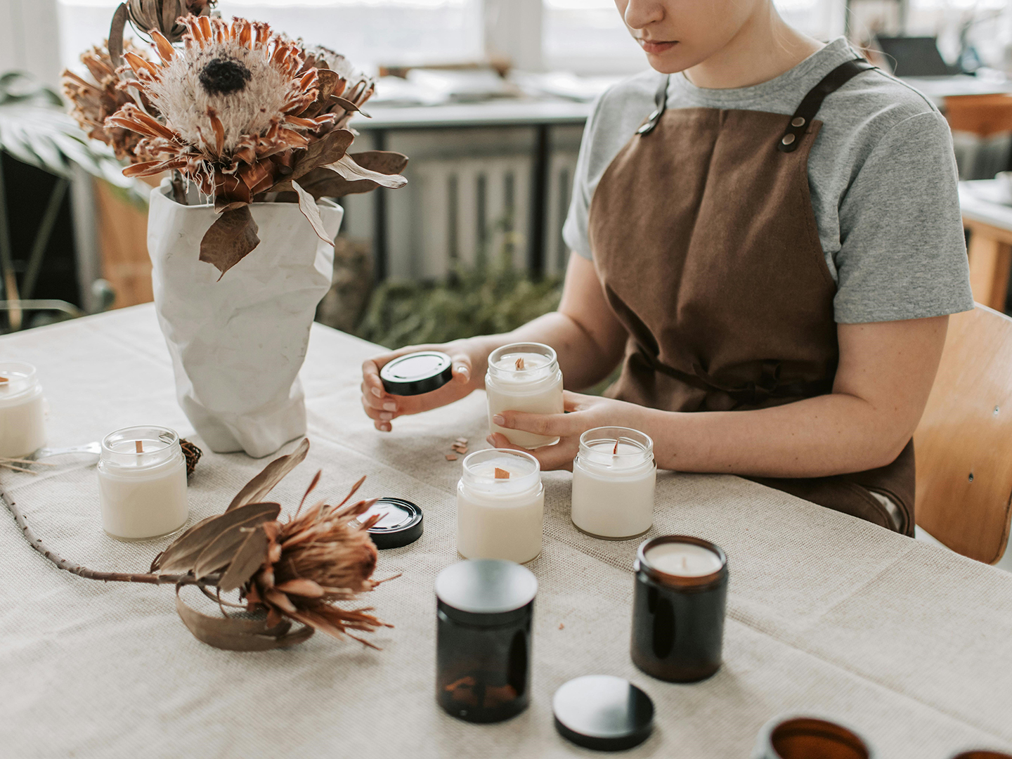 Young woman running her own candle business.