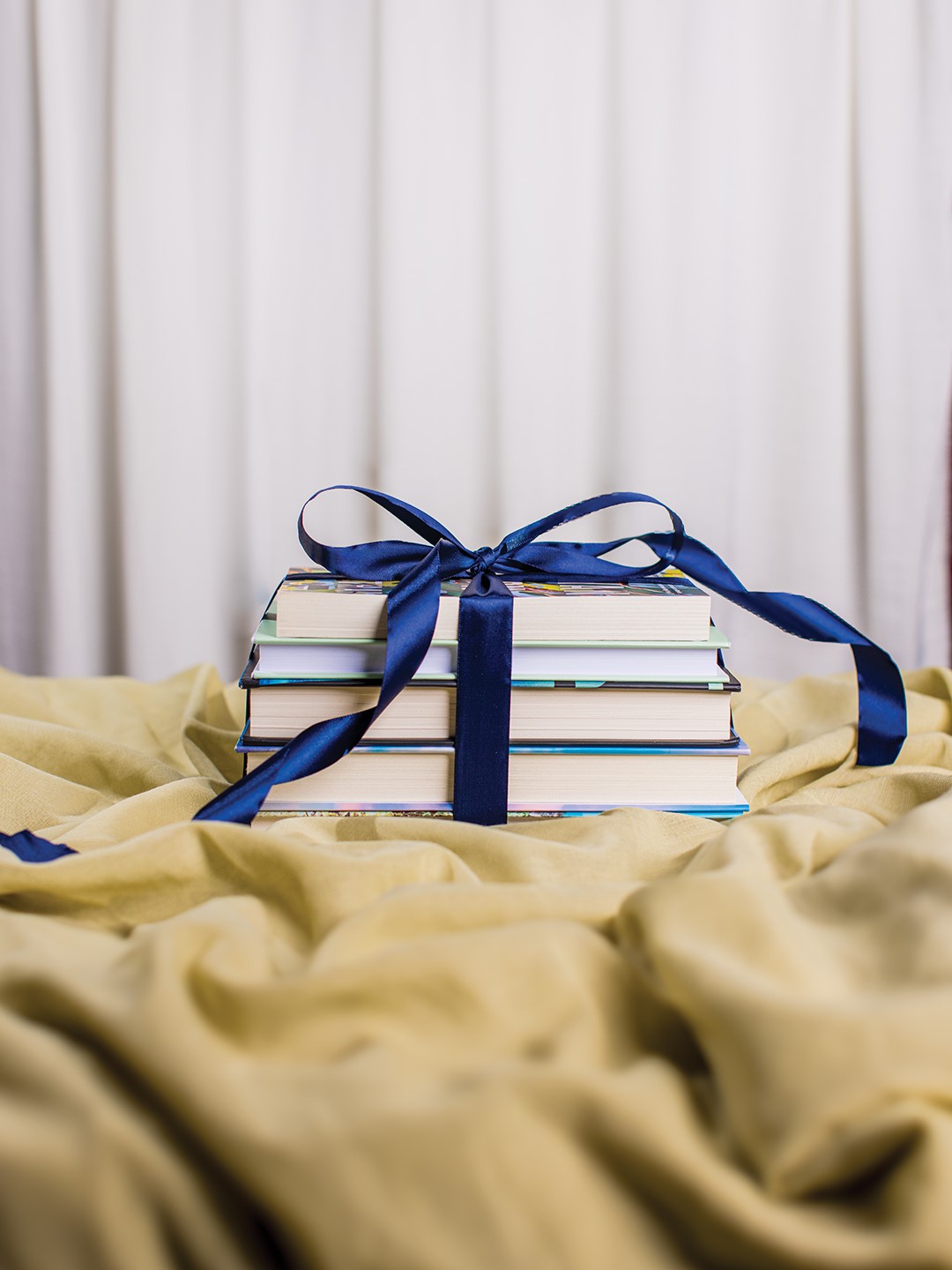 Stack of books wrapped with a bow
