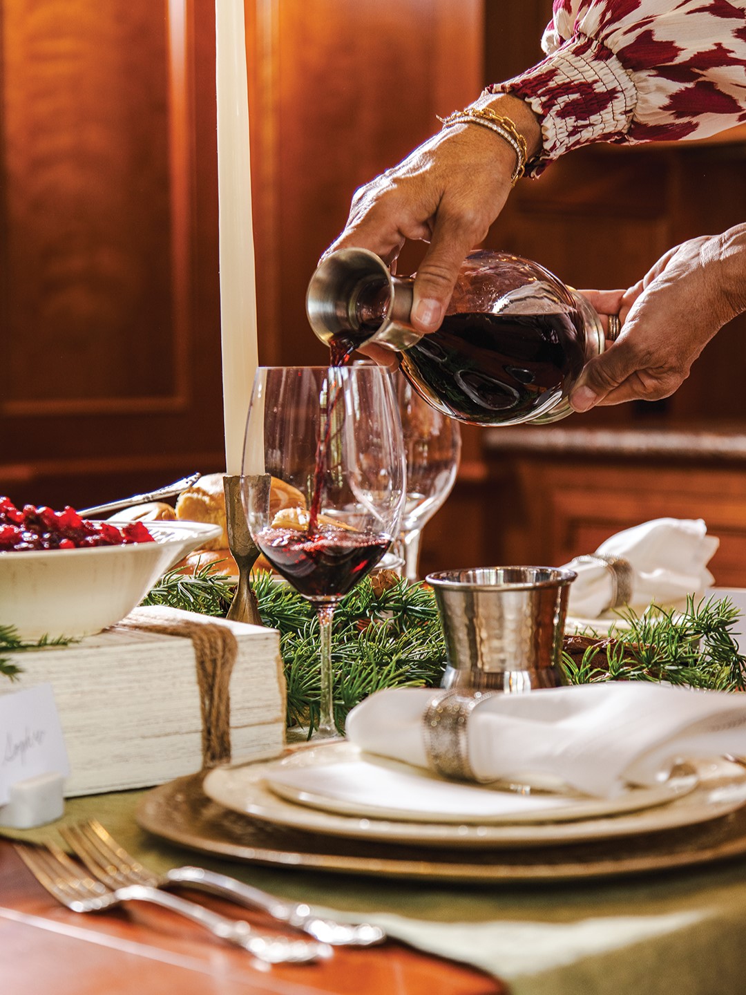 Leona Rose Interiors tablescape with hands pouring a glass of wine