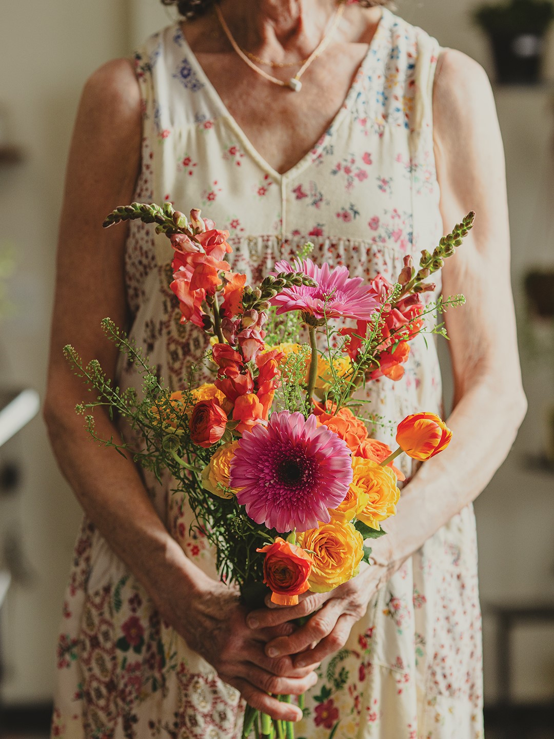 Kim Bauer holding a colorful bouquet