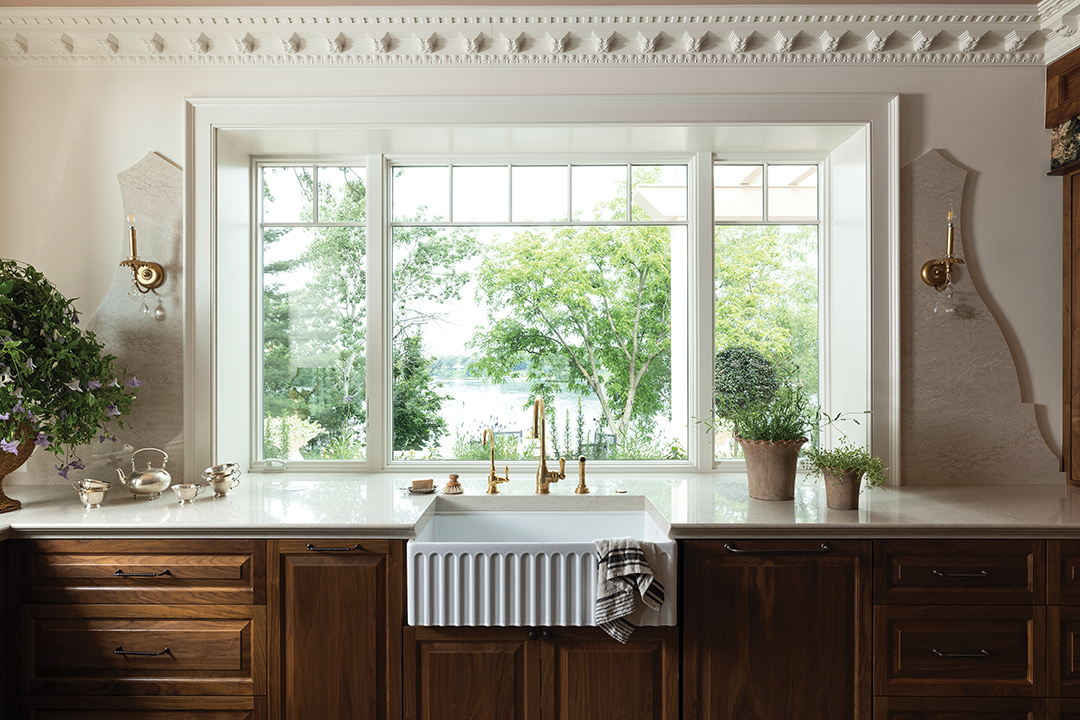 To highlight the view of White Bear Lake from indoor spaces, the originally tucked-away kitchen was moved lakeside, becoming an oasis of light that allows Anna Shroyer to keep tabs on the yard and lake. And the sink is not the only place with a view; windows line the entire kitchen, even behind the range. The room is one of her favorite places to watch the sunset. “We get the most amazing sunsets … it never gets old,” Anna says.