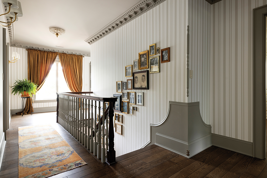 The photo gallery above one of the home’s original staircases was a surprise from Blue Pencil Collective (BPC). Regan Nix, BPC co-founder, recalls watching homeowner Anna Shroyer walk up the stairs with tears in her eyes, taking in the wall and memories made tangible. “Our blended family has been together for five years now, so even feeling like our new blended family has history was really cool,” Anna says.
