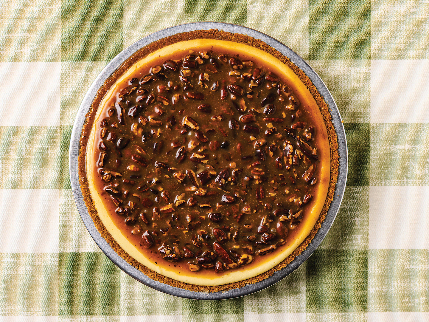 The creamy and tangy Caramel Pecan Cheesecake is topped with homemade sea salt caramel and toasted pecans.